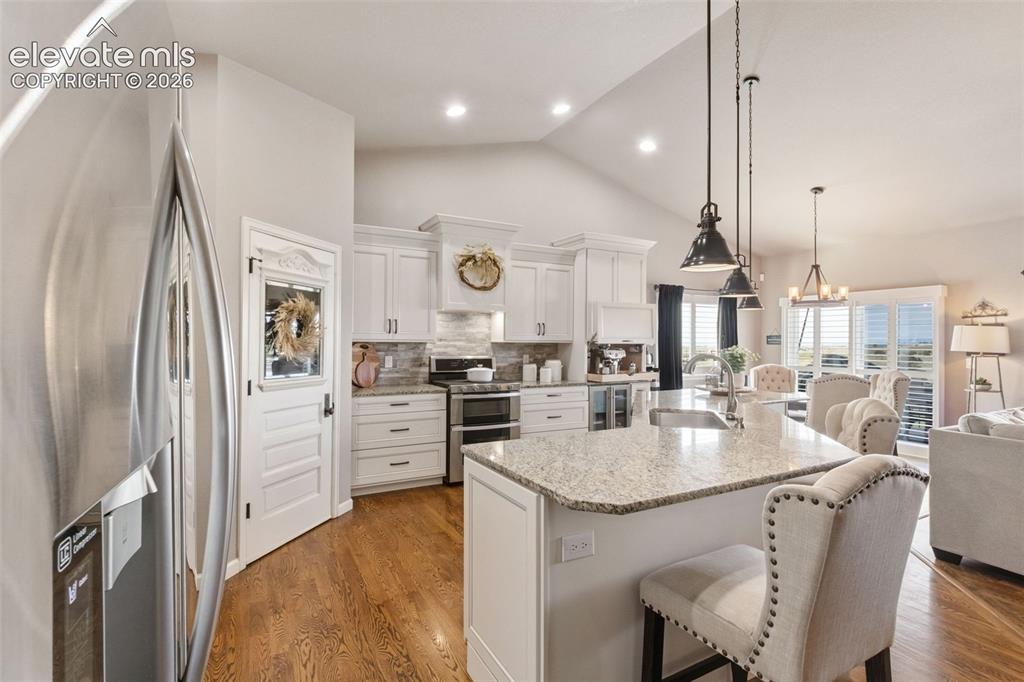 Image 6 of 40: Gorgeous thoughtfully upgraded kitchen with walkout and 100 yr old repurpos