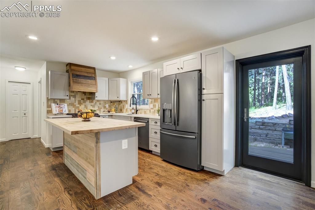 Image 11 of 50: Renovated kitchen combines wood elements, stone, and tile perfectly!