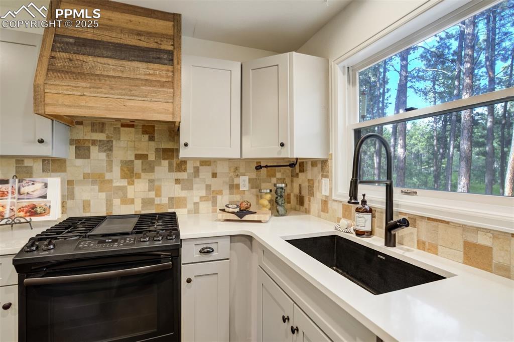 Image 12 of 50: Imagine doing dishes while gazing at your gorgeous backyard!