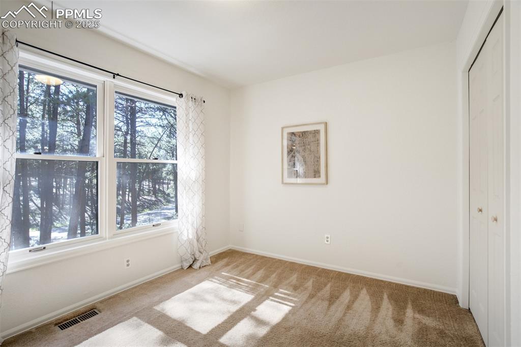 Image 28 of 50: A 4th bedroom upstairs with lovely large picture window