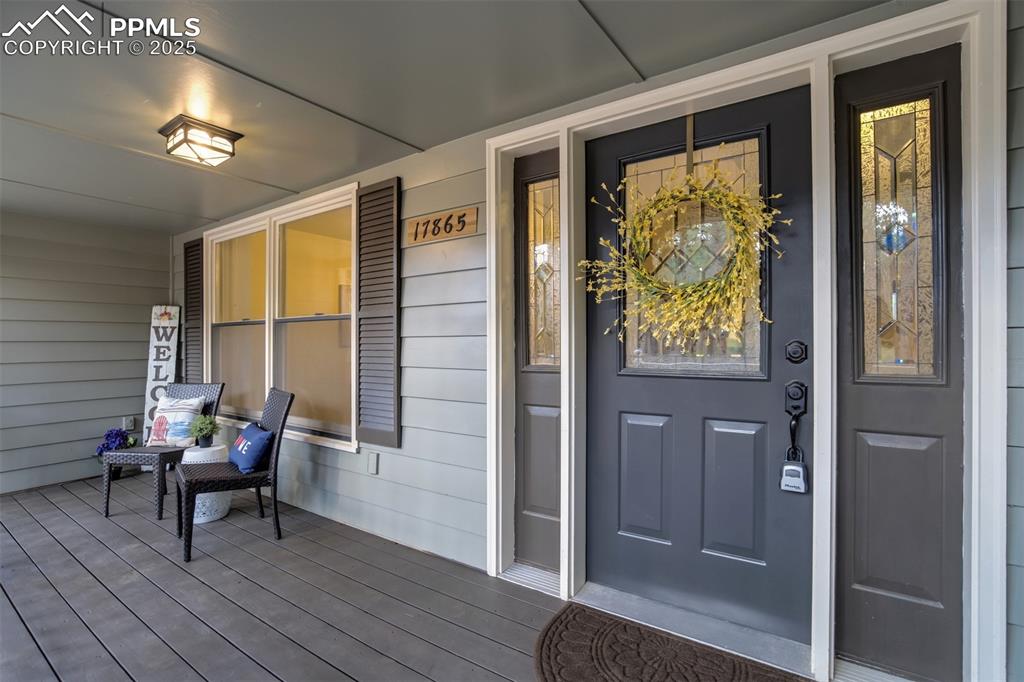 Image 6 of 50: Large covered front porch; perfect to enjoy a favorite beverage