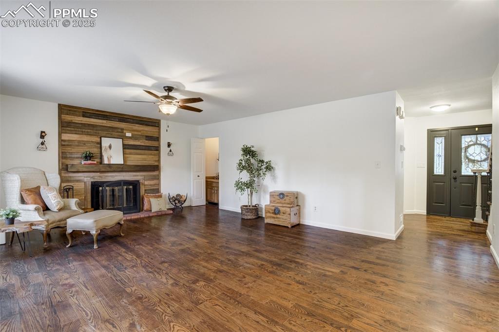 Image 7 of 50: The front entry and the living room; gorgeous wood floors greet you!