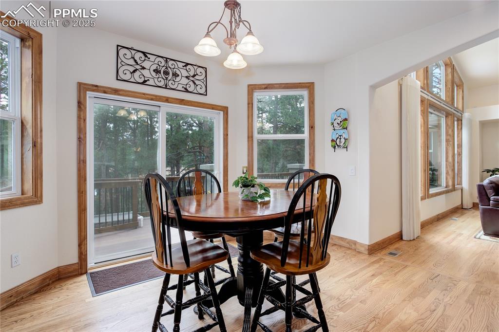 Image 10 of 41: Dining nook w/ walk-out to deck