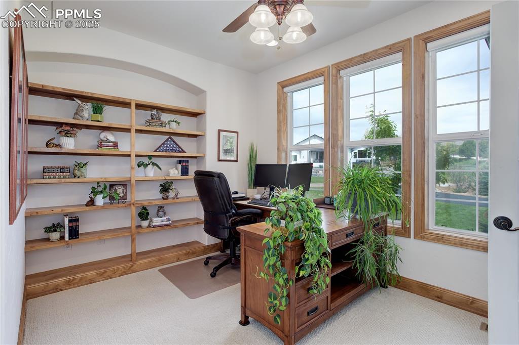 Image 18 of 41: Main level office w/ French doors & shelves