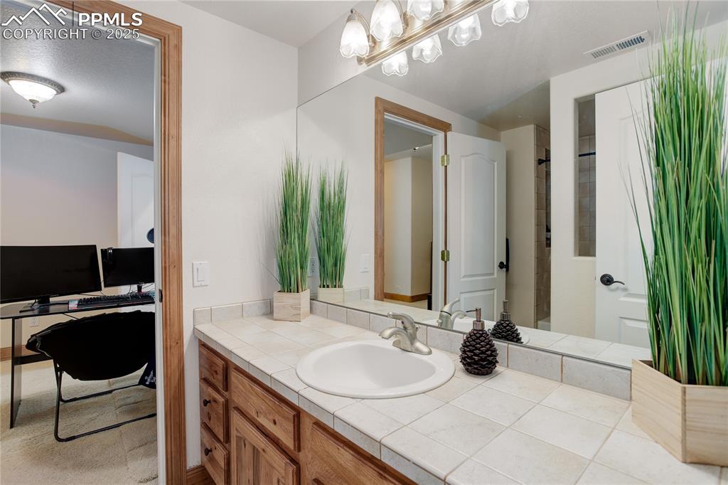 Image 30 of 41: Private full bath for Bedroom 4