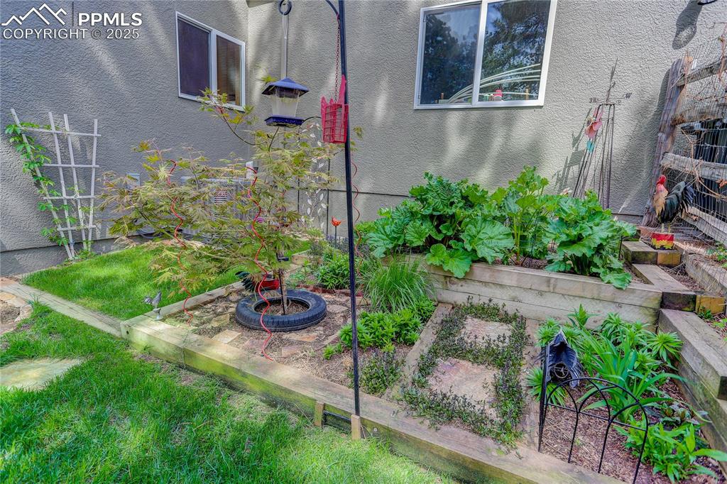 Image 33 of 41: Fenced flower & garden beds