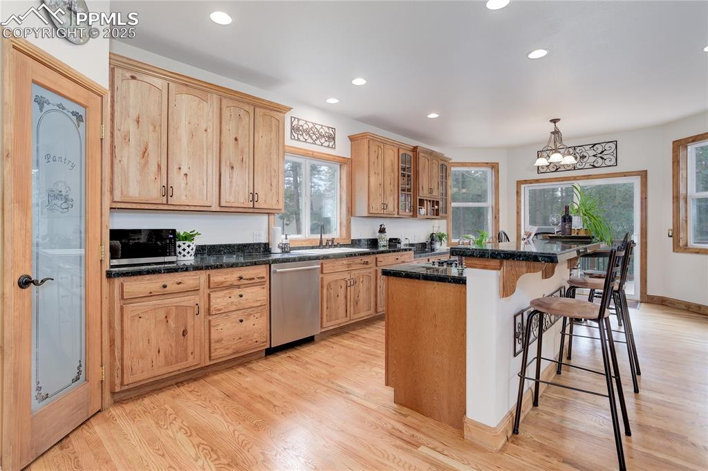 Image 8 of 41: Knotty alder cabinets & barstool seating