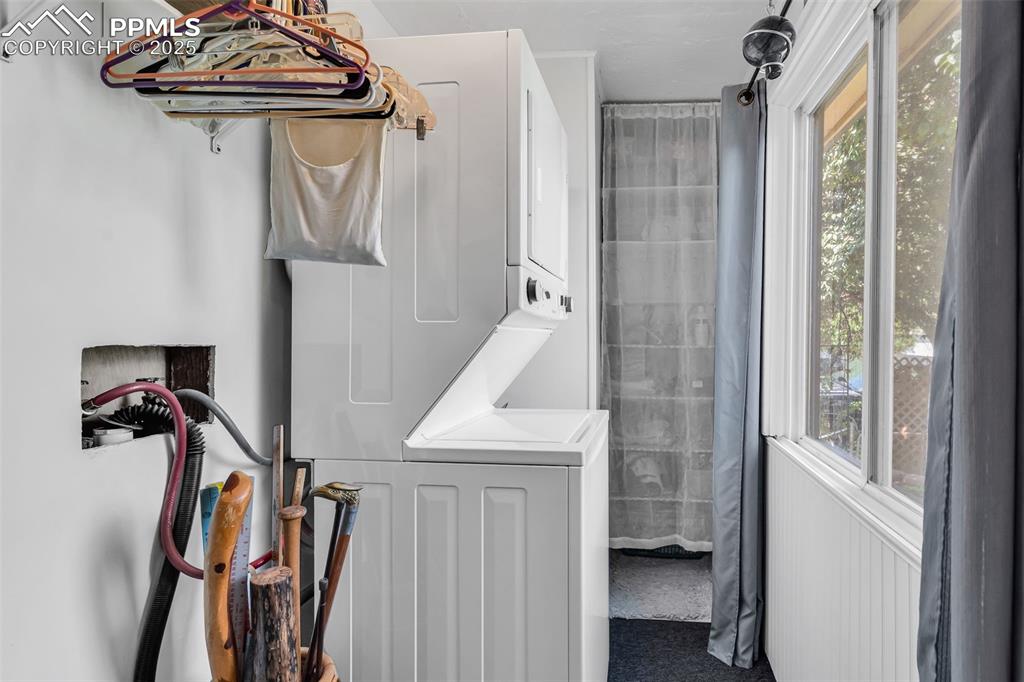 Image 12 of 44: The laundry is located off the kitchen and features a window and storage sp