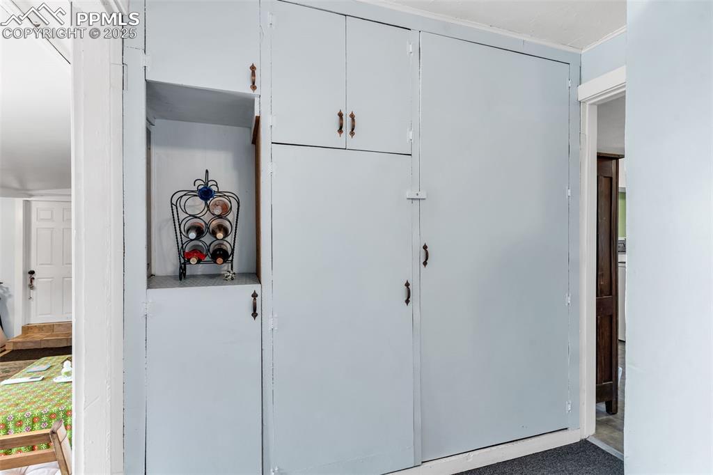 Image 14 of 44: The hall to the kitchen provides more storage and the pantry.