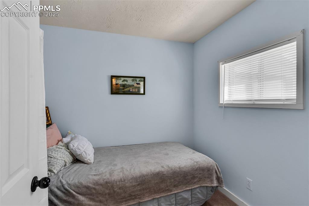 Image 20 of 44: A small non-conforming bedroom or study is located next to the living room.
