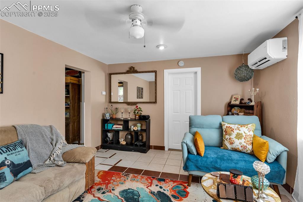 Image 3 of 44: From the entry, step into the living room with a ceiling fan leading to a g