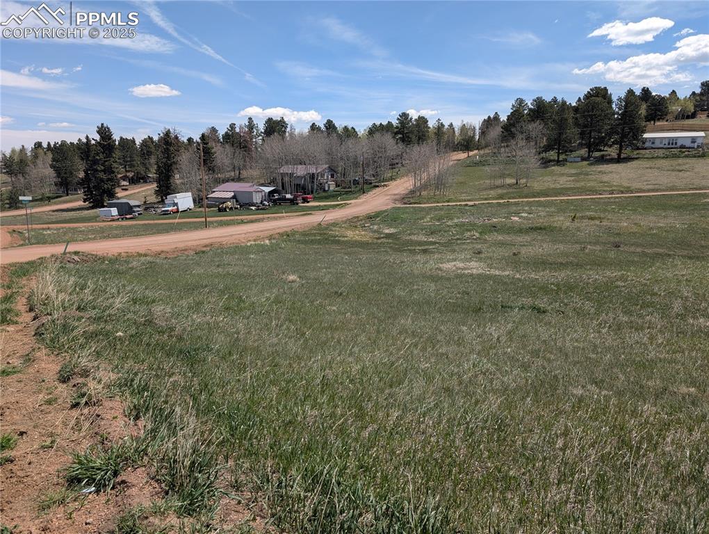 Caption: View of grassy yard with a view of rural / pastoral area