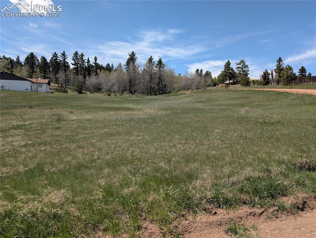 Image 2 of 12: View of grassy yard with a view of countryside