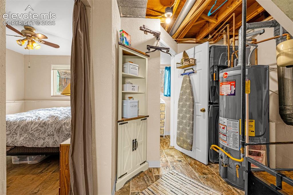Image 14 of 30: Built-in corner cabinetry with wood-toned shelving, tile flooring, and expo