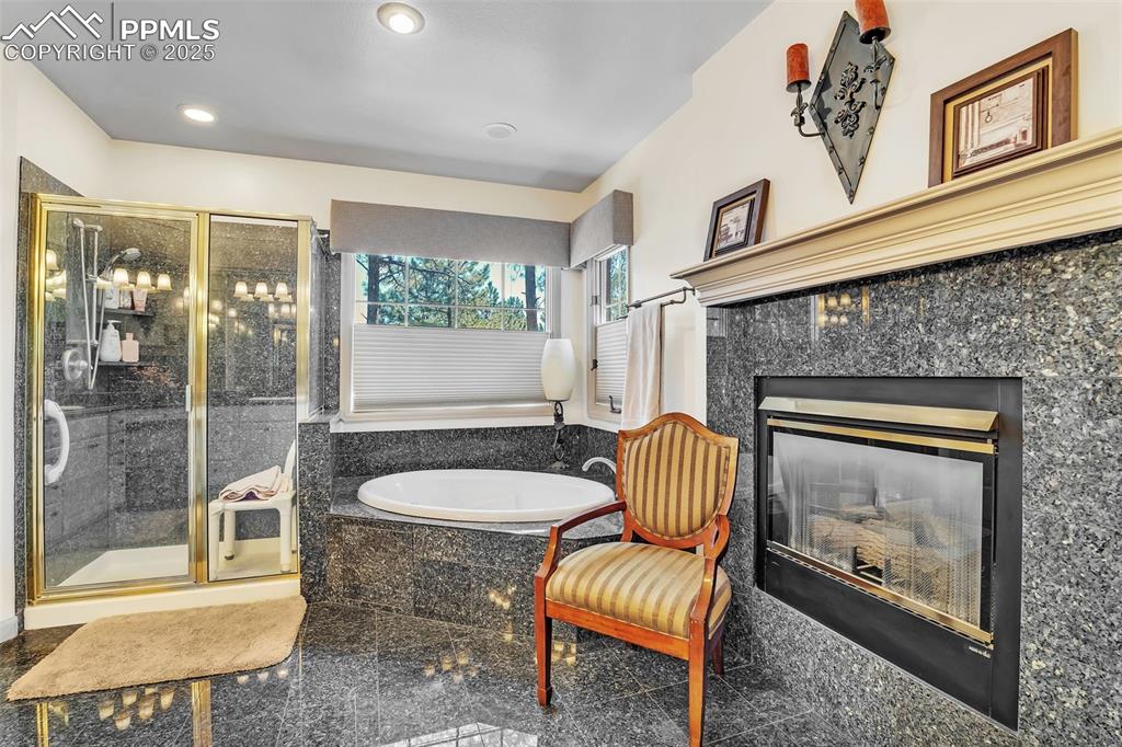 Image 19 of 45: Sitting room with recessed lighting and a high end fireplace