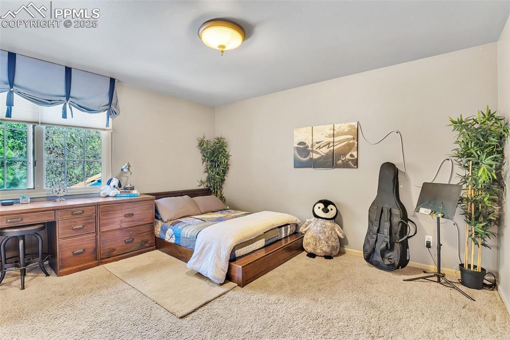 Image 23 of 45: Bedroom featuring baseboards and carpet floors