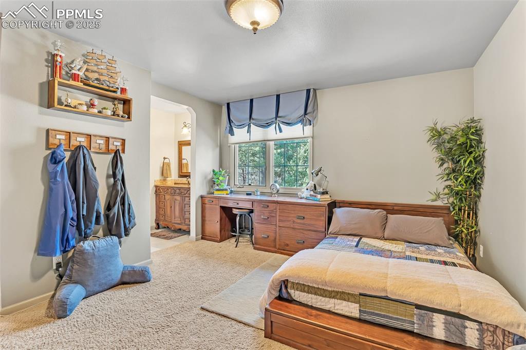 Image 24 of 45: Carpeted bedroom featuring ensuite bathroom