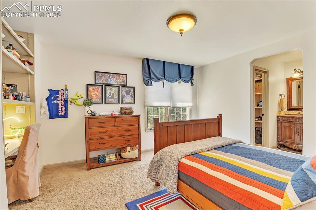 Image 25 of 45: Bedroom featuring arched walkways, baseboards, and carpet
