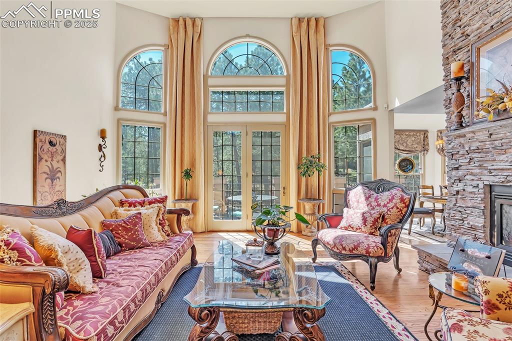 Image 3 of 45: Living area with wood finished floors and a high ceiling