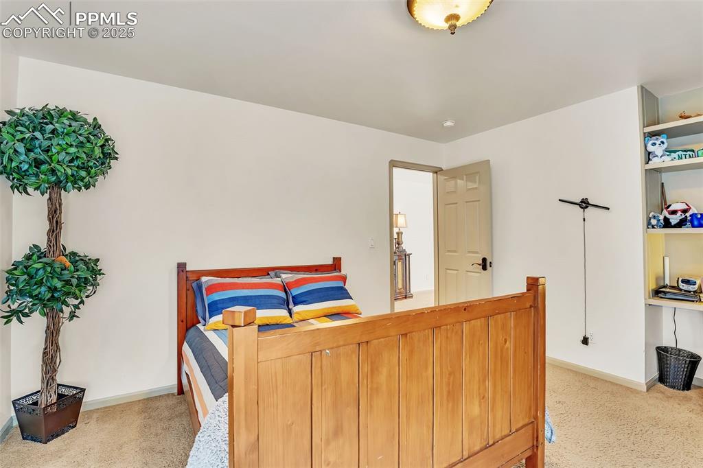 Image 31 of 45: Carpeted bedroom featuring baseboards
