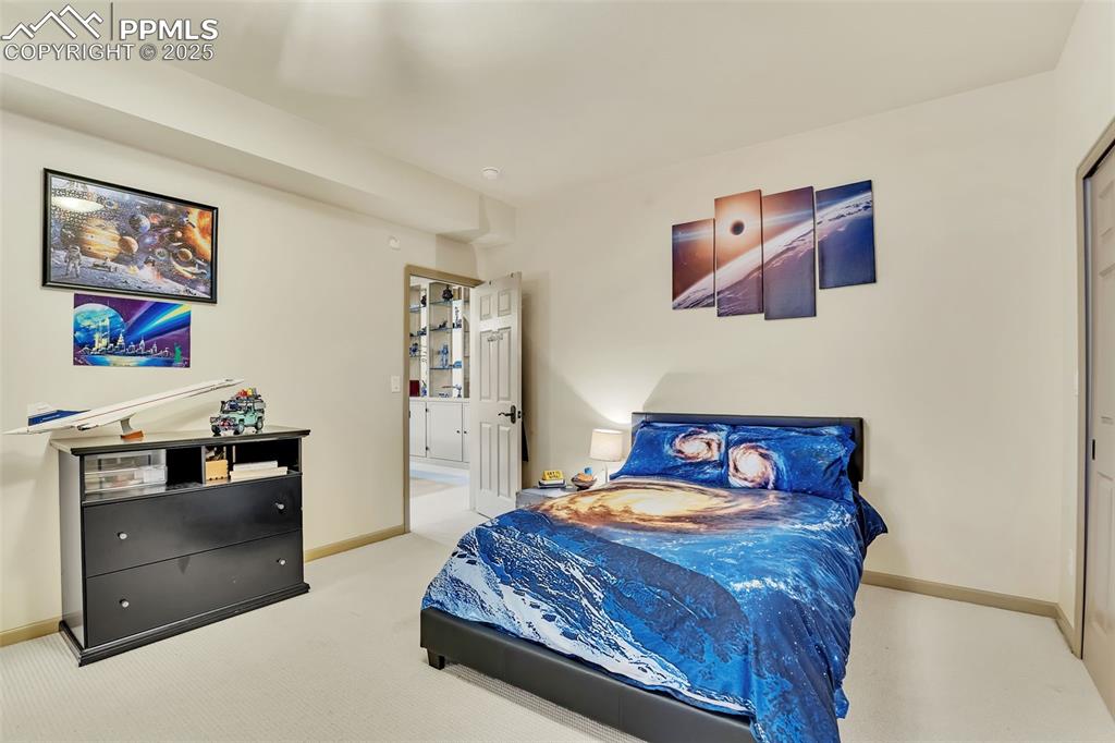 Image 33 of 45: Bedroom featuring baseboards and carpet