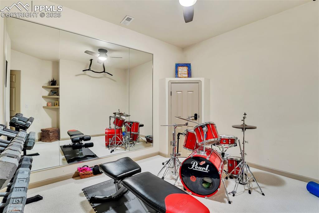 Image 40 of 45: Workout area with baseboards, a ceiling fan, visible vents, and carpet