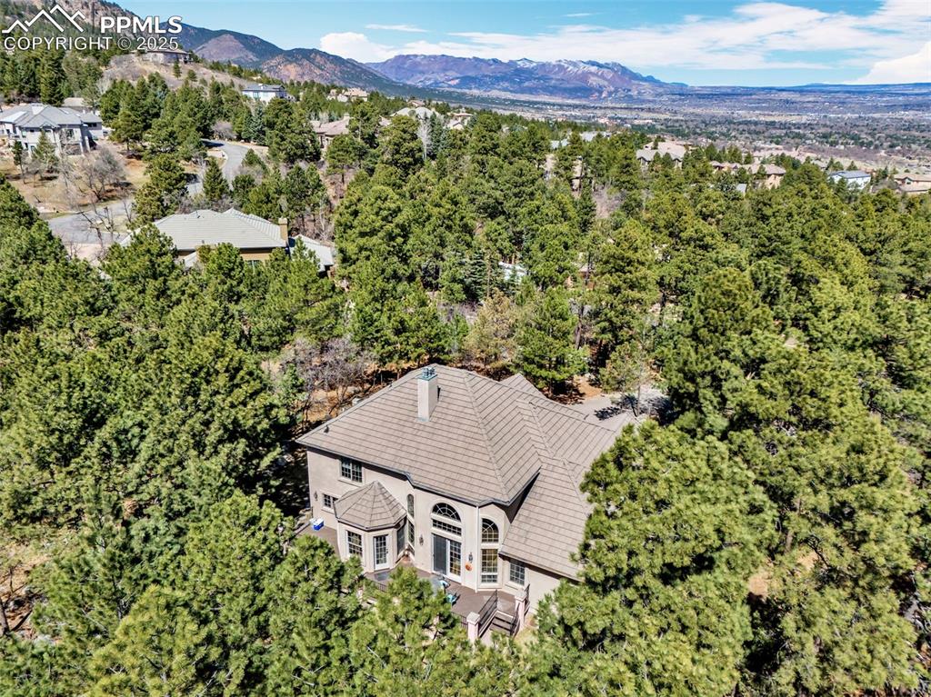Image 44 of 45: Birds eye view of property with a mountain view and a view of trees