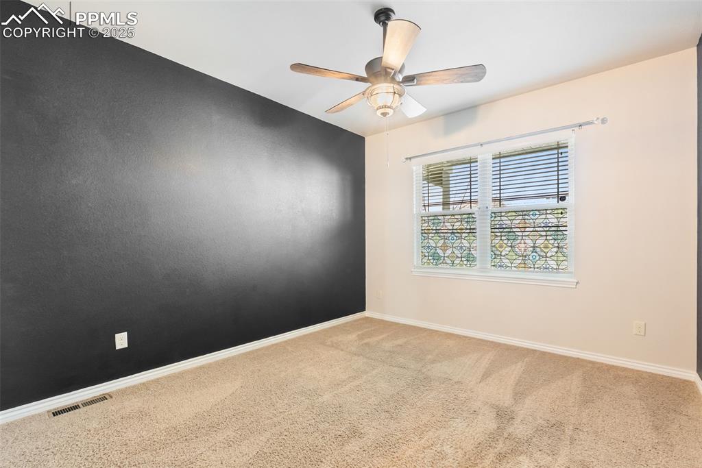 Image 16 of 43: Spare room featuring light carpet and a ceiling fan