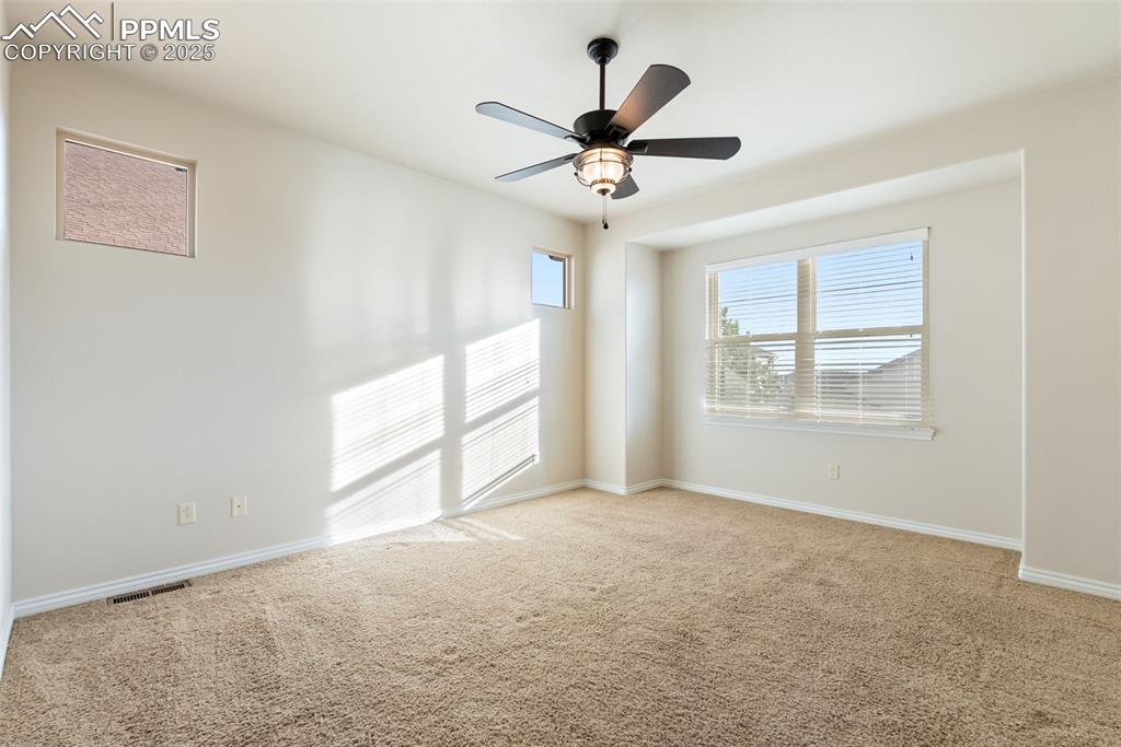 Image 20 of 43: Carpeted spare room with baseboards and a ceiling fan