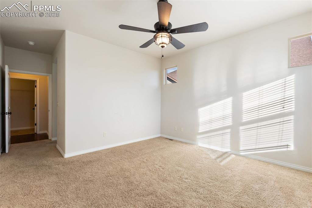 Image 21 of 43: Empty room featuring carpet floors and a ceiling fan