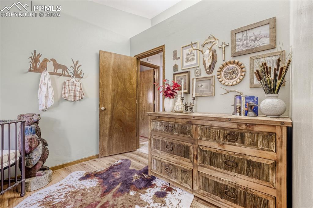 Image 18 of 27: Hallway with light wood-style flooring and baseboards