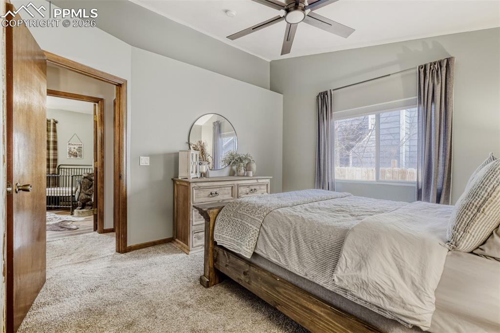 Image 21 of 27: Carpeted bedroom featuring ceiling fan and baseboards