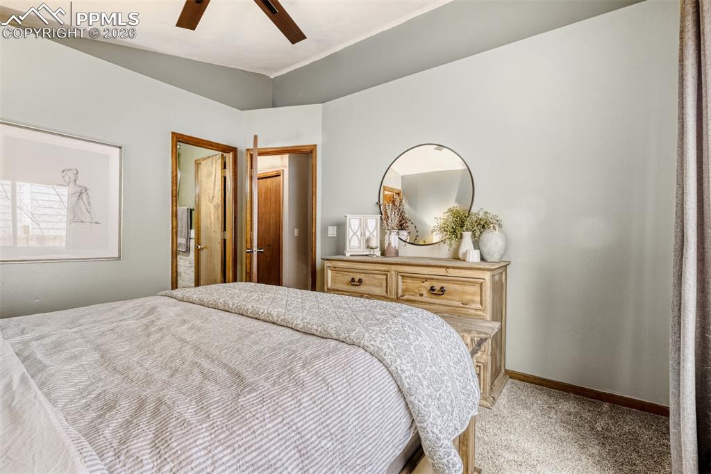Image 22 of 27: Bedroom with light carpet and ceiling fan