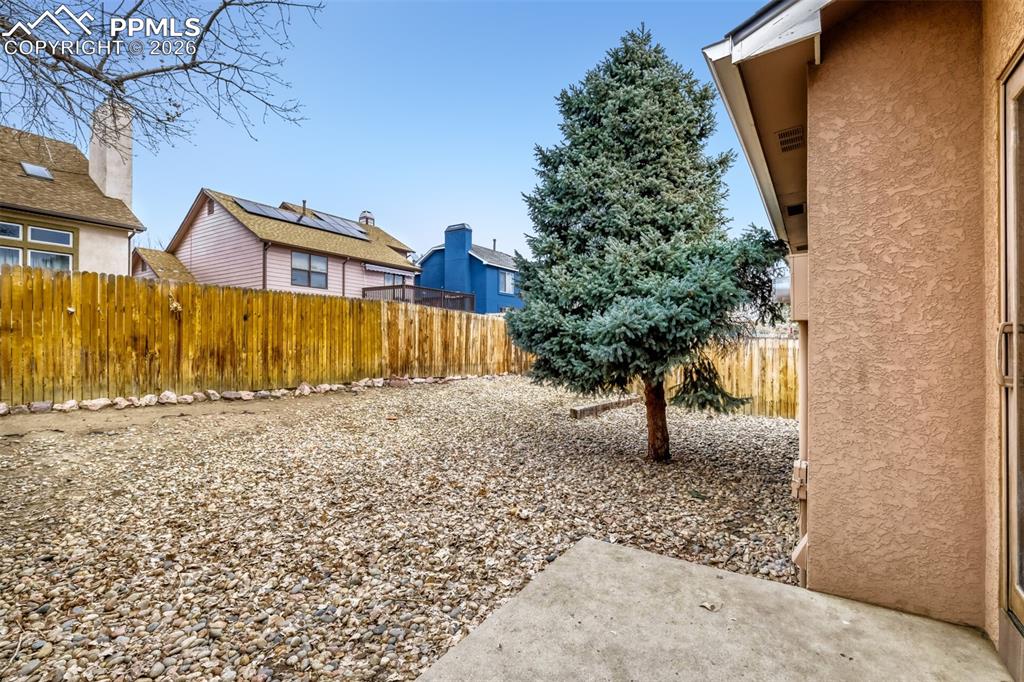 Image 23 of 27: Fenced backyard featuring a patio area