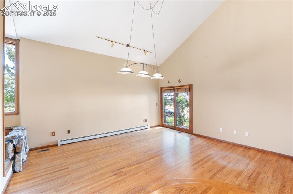 Image 10 of 50: Vaulted Ceilings And Double Doors Leading Outside