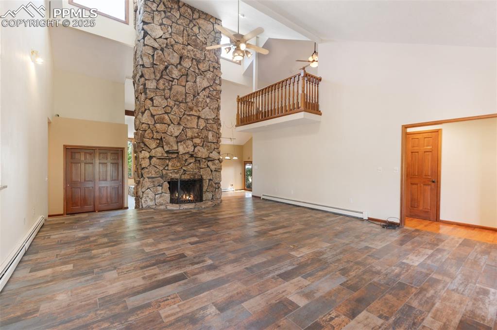 Image 6 of 50: Stunning Living Room w/20 Ft. Stone Fireplace & Skylights!