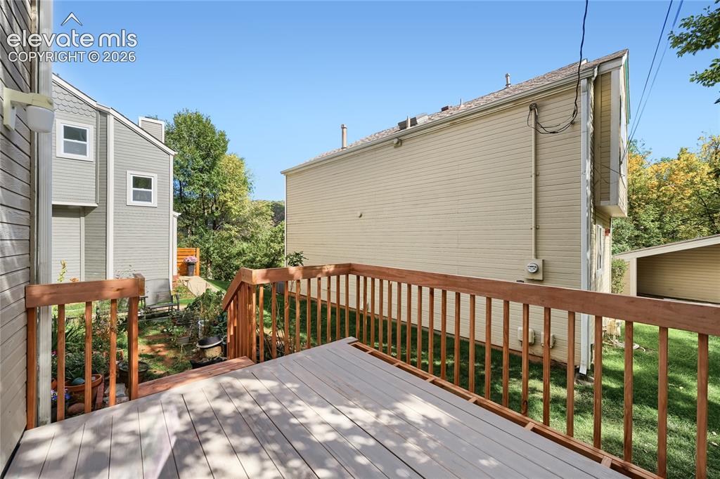 Image 27 of 37: Spacious composite deck featuring wood-finish railings and multiple levels,