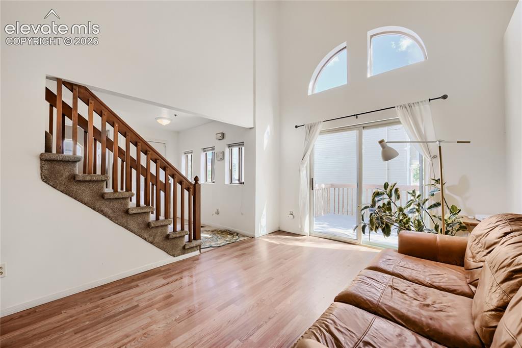 Image 6 of 37: Bright, open foyer showcasing gleaming wood-finish flooring, a striking woo