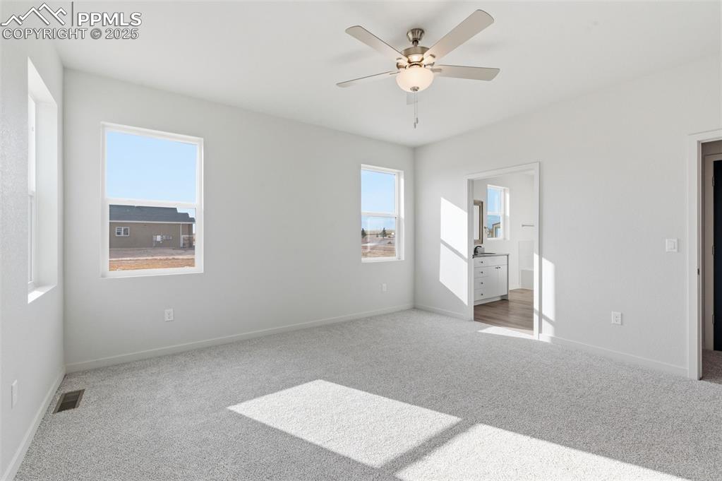 Image 16 of 30: Unfurnished bedroom with carpet and a ceiling fan