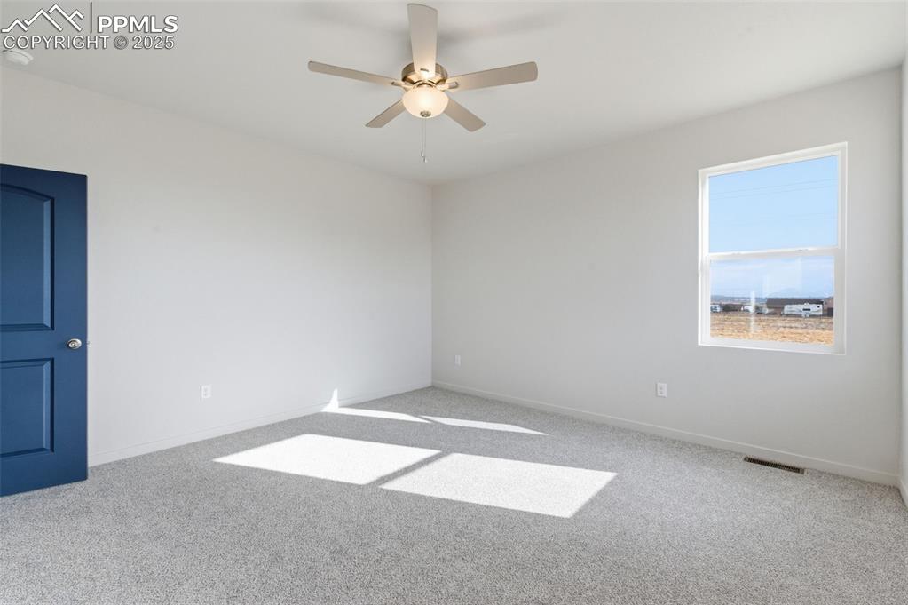 Image 18 of 30: Spare room with light colored carpet, ceiling fan, and a smoke detector