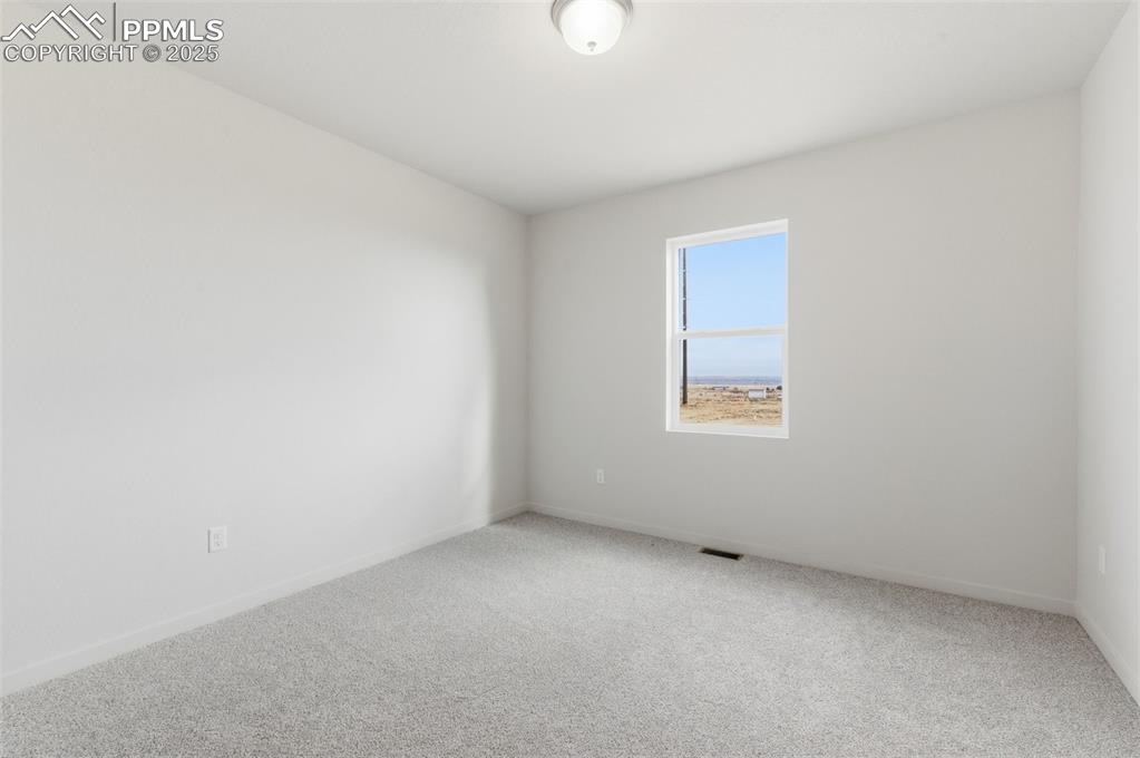 Image 23 of 30: Carpeted spare room featuring baseboards
