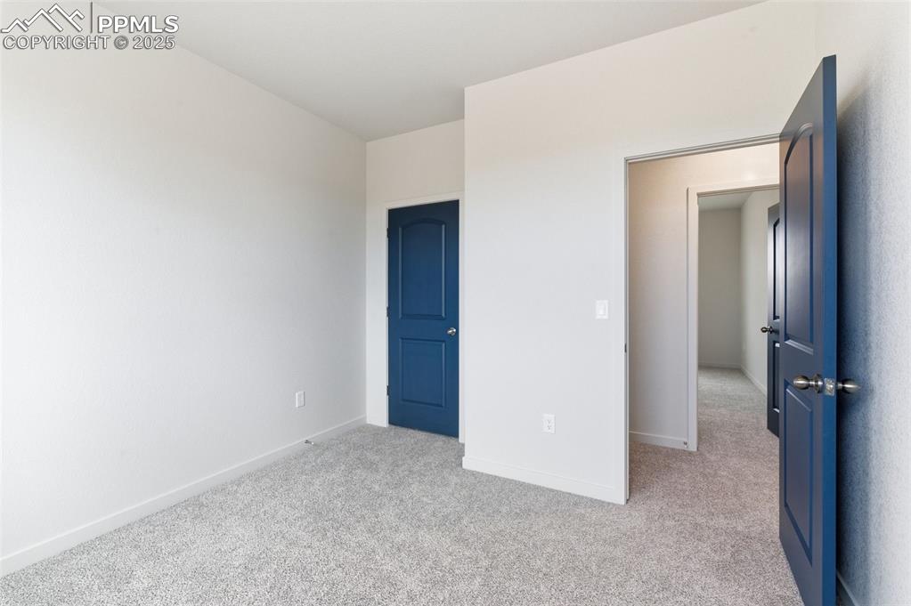 Image 27 of 30: Unfurnished bedroom with light carpet and baseboards