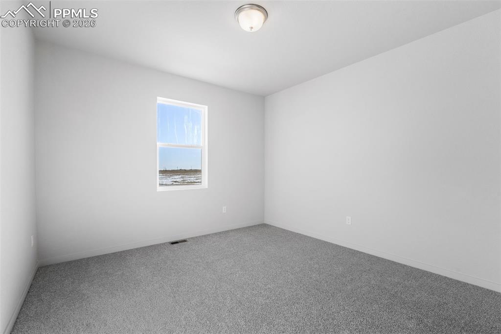 Image 32 of 46: Spare room with carpet floors and baseboards