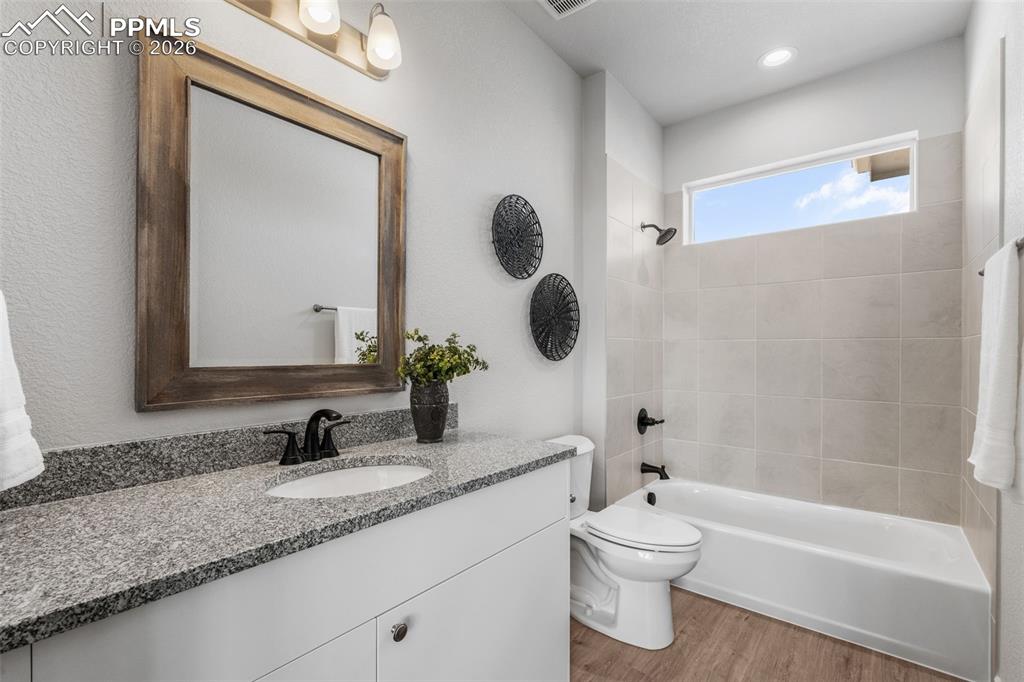 Image 34 of 46: Bathroom with vanity, tub / shower combination, and light wood-type floorin