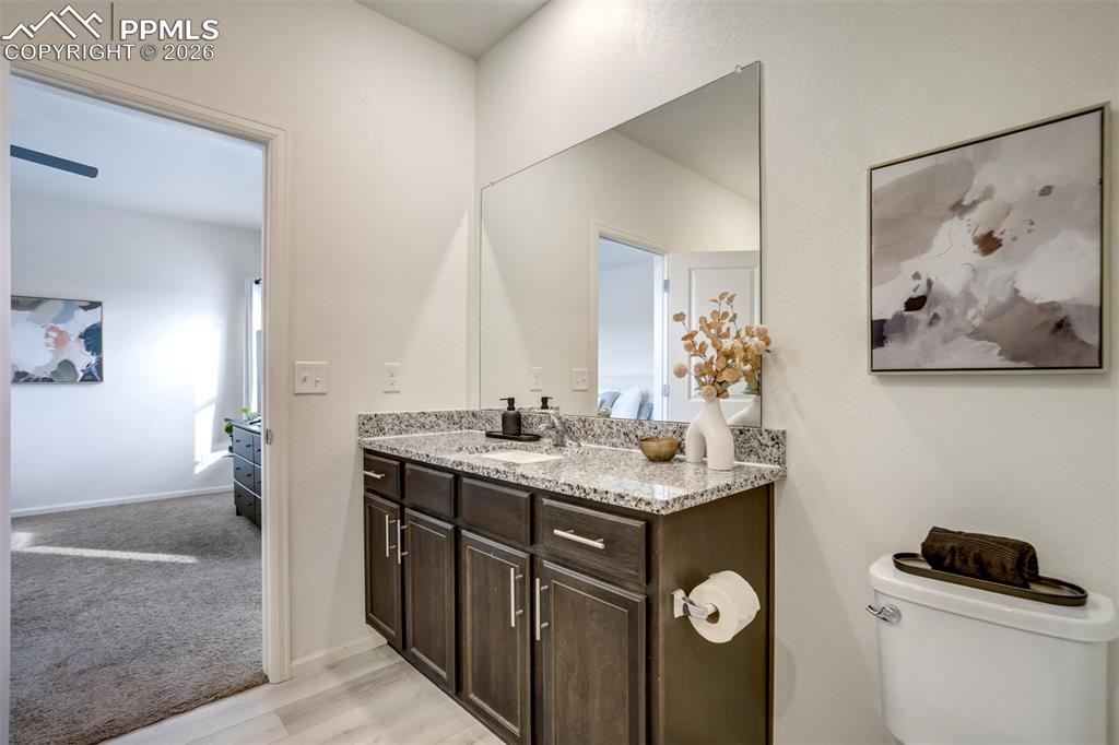 Image 21 of 41: Granite in the bathroom with LVP flooring. 
