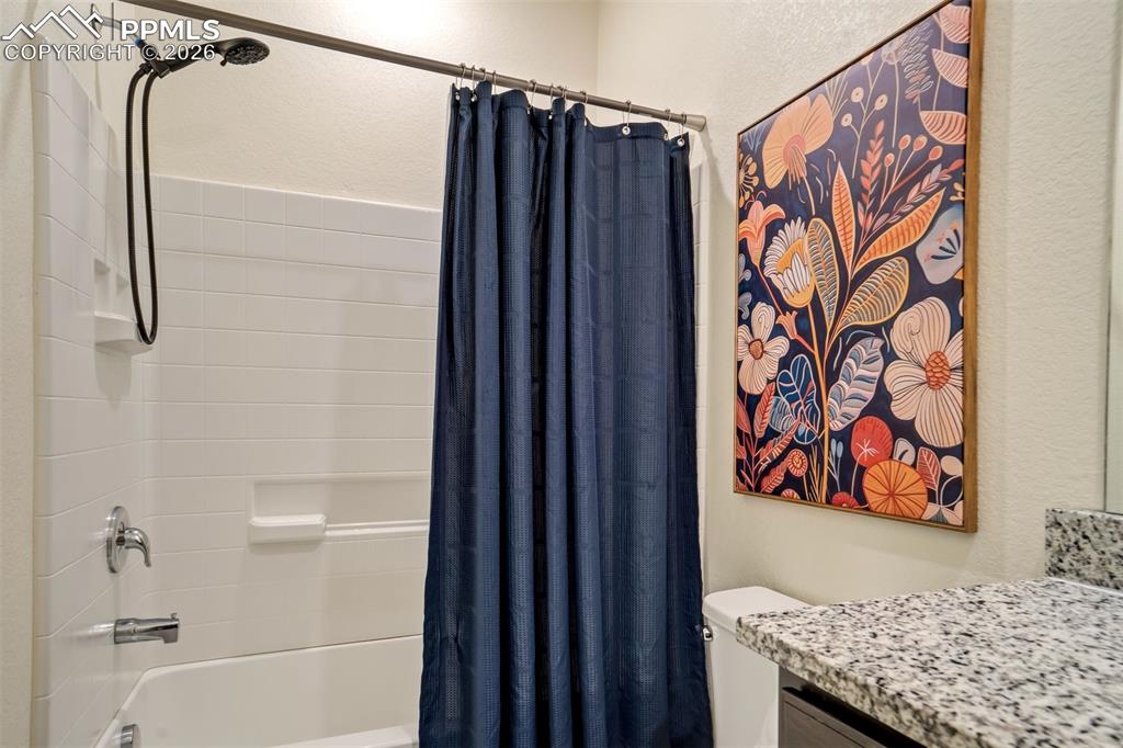Image 30 of 41: Shower/ tub and granite countertops. 