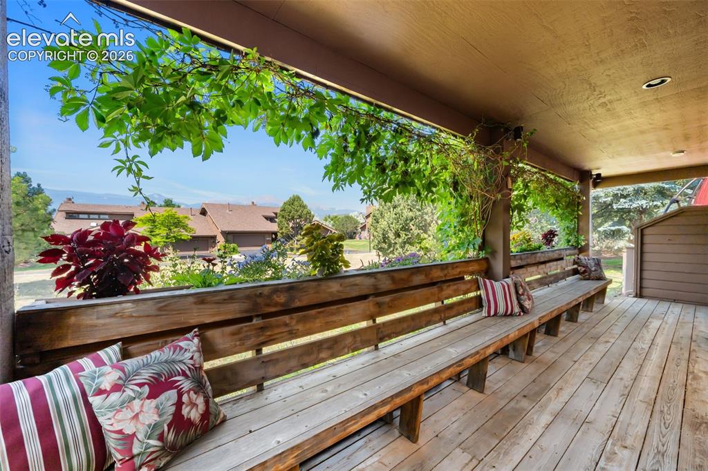 Image 37 of 48: Expansive outdoor covered patio featuring built-in wooden bench seating, na