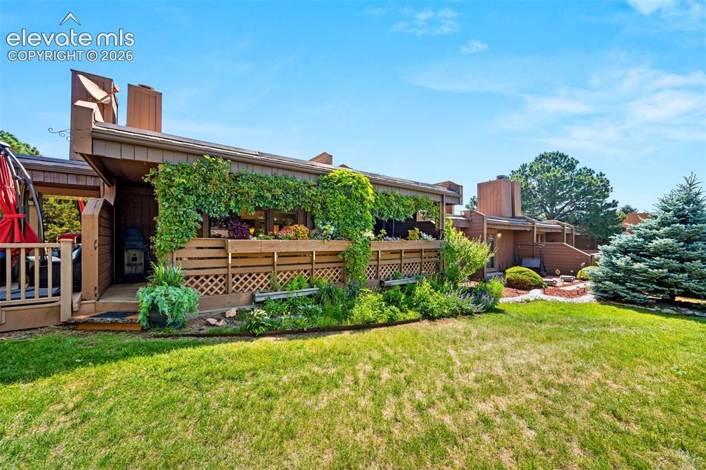 Image 38 of 48: Multi-level exterior featuring a wooden deck with lattice detailing and an
