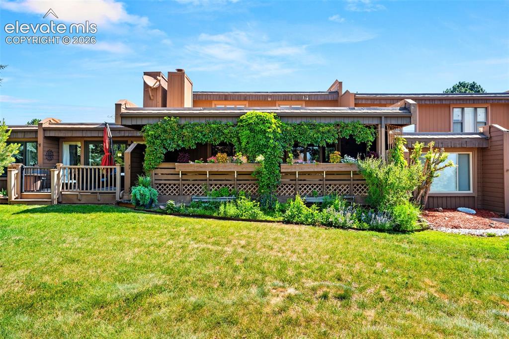 Image 39 of 48: Manicured lawn leading to a private deck with lattice screening and integra