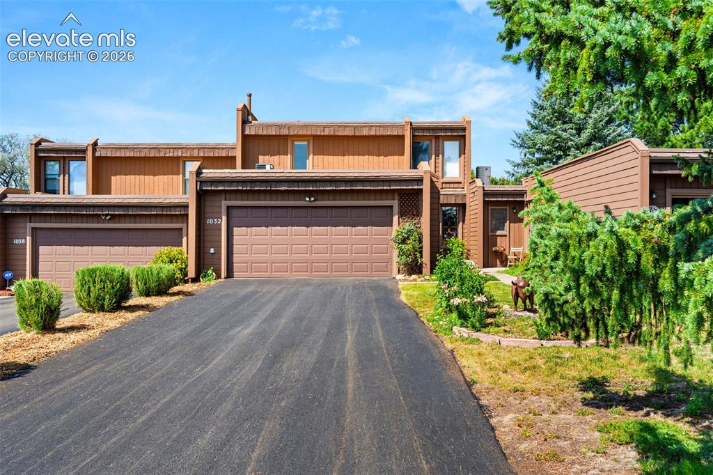 Image 41 of 48: Contemporary townhouse exterior featuring brown siding